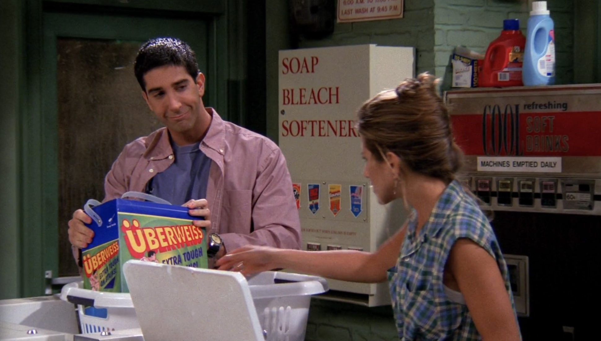 Ross holding uberweiss in a laundry basket in front of Rachel